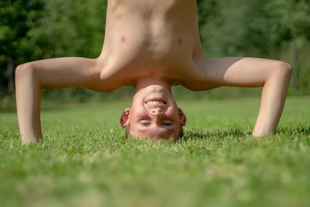 boy, game, nature, child, standing on your head, luck, summer, exercises, gymnastics, childhood, carefree, holiday, joy. Does a childhood photo games image survive a check before the sheet?